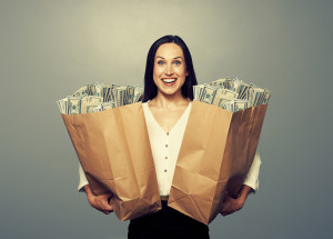 woman holding two paper bags with money