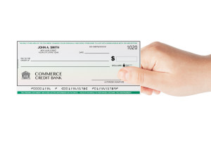 Banking Check holded by hand on a white background